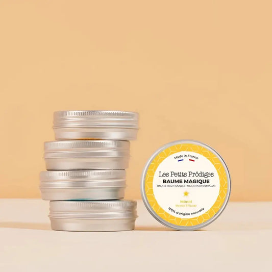 Stack de cinq boîtes en métal argenté avec un baume multi usage fleur de coton 100mL