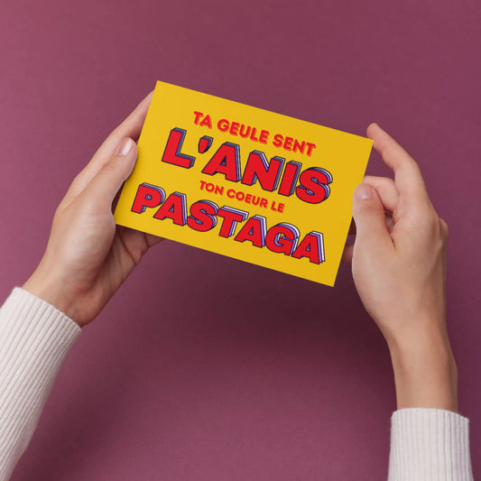 Carte postale jaune vif avec texte rouge: Ta gueule sent l’anis, ton cœur le pastaga, pour moments authentiques