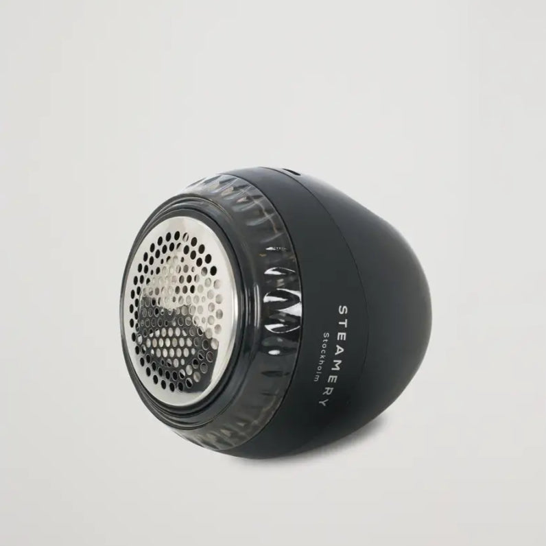 Rasoir anti-bouloche noir avec tissu noir et tête métallique pour éliminer bouloches