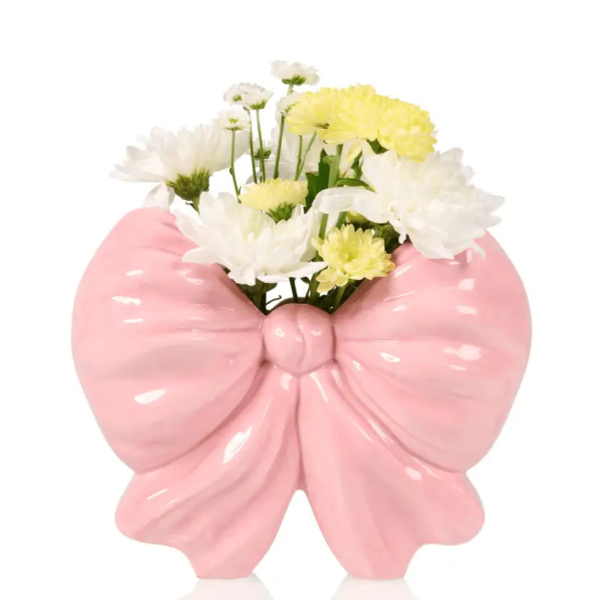 Vase noeud rose avec fleurs blanches et jaunes pour une expérience unique