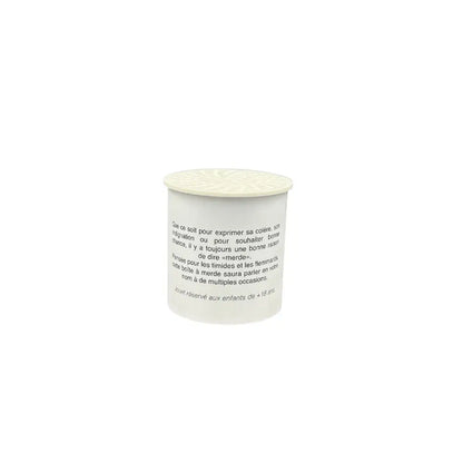 Contenant cylindrique blanc avec un couvercle clair contenant un objet rigolo de Boite à son merde