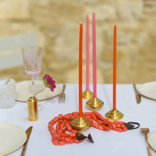 Bougeoir en laiton pour bougies fines avec candles oranges et roses, style années folles