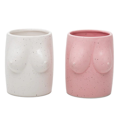 Deux cache pots boobs en céramique, blanc mat et rose doux tachetés, torses féminins stylisés pour déco décomplexée