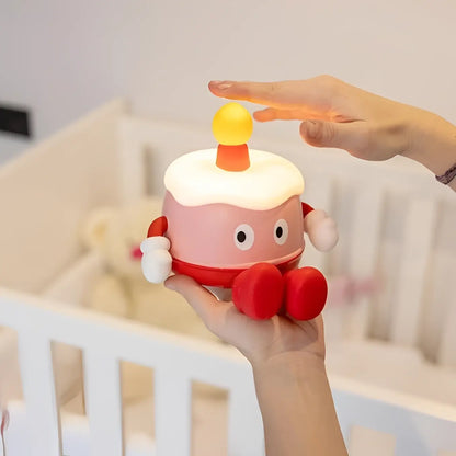 Lampe nuit gâteau rose rouge avec glaçage blanc, yeux gogues et bougie jaune pour ambiance douce