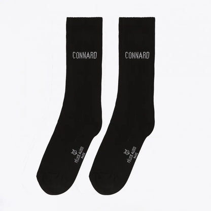 Chaussettes connard noires avec clin d’œil au mot connard sur cheville