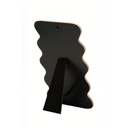 Miroir Vague Rose en forme ondulée teinte rose poudré avec cadre noir