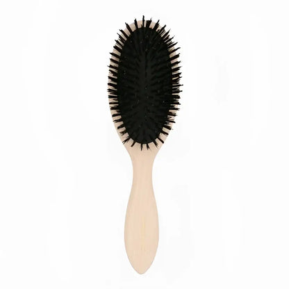 Brosse à cheveux ovale petite avec manche clair et poils noirs pour soin capillaire