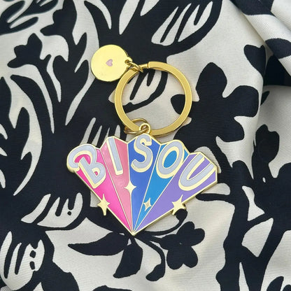 Porte-clé Bisous doré avec fan charm aux couleurs éclatantes