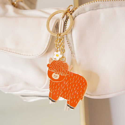 Porte-clés highland cow orange émaillé avec fleur blanche