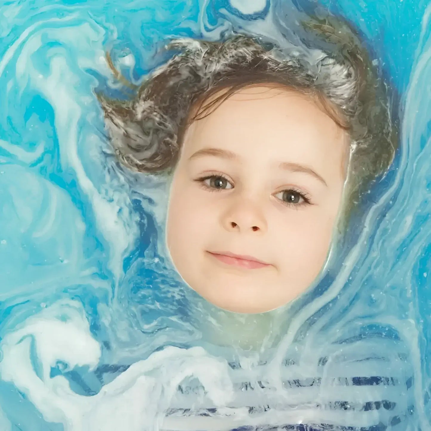 Visage enfant dans eau bleue tourbillonnante, bain crépitants bleu