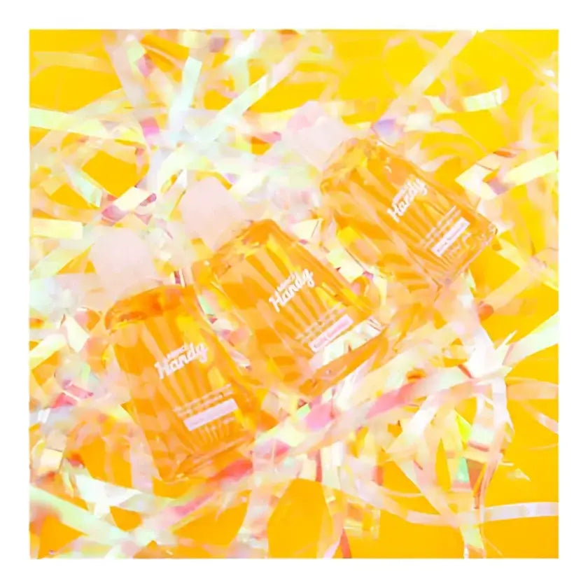 Trois bouteilles translucides orange de nettoyant gel Hello Sunshine 30ml parmi confettis colorés