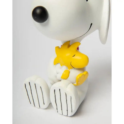Statue Snoopy tenant Woodstock, symbole d’amitié avec touche d’humour