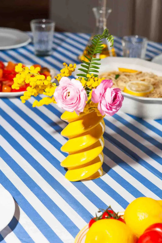 Vase Fusilli en spirale jaune vibrant avec roses roses et mimosas jaunes, objet décoratif ambiance chaleureux